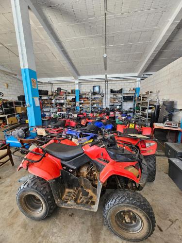 a room with a bunch of parked dirt bikes at Albergue Centro de Ocio Luis Miguel in Fresno de la Fuente