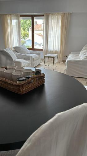 a bedroom with two beds and a table with bowls on it at C&M in Mar del Plata