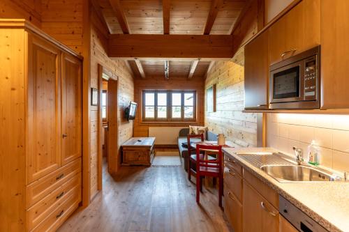 a kitchen with a sink and a table in a cabin at Madlhof in Himmelreich