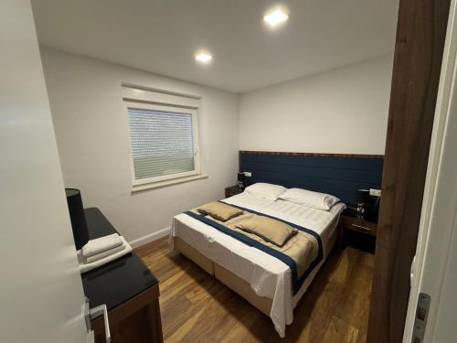 a bedroom with a large bed and a window at Central in Dubrovnik