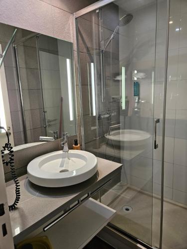 a bathroom with a sink and a glass shower at studio classé 3 étoiles, Anglet Chiberta ocean golf surf in Anglet