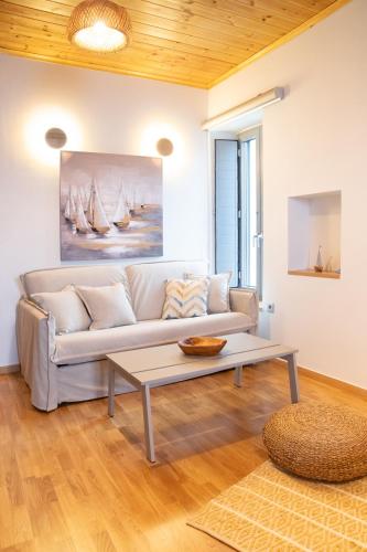 a living room with a couch and a coffee table at Selana και Ielios Trikerisuites in Tríkeri