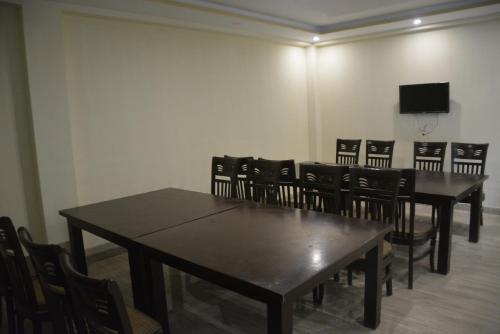 a conference room with tables and chairs and a flat screen tv at Hotel Rock Star, Naran in Nārān