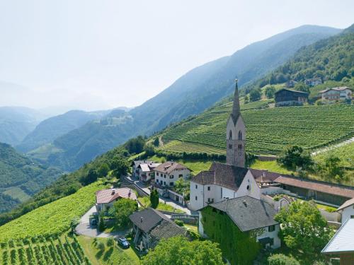 a small village in a vineyard with a church at Apartement Huck in Cornedo all'Isarco