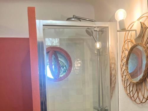 a shower with a glass door in a bathroom at Santa Margarita in Saint-Raphaël