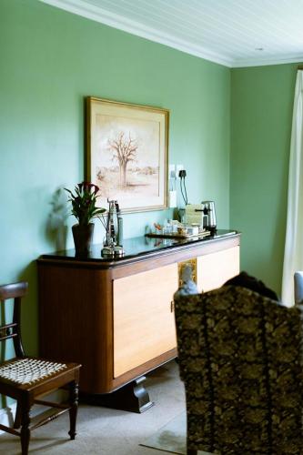 a desk in a room with a picture on the wall at Vineyard Views Country House in Riebeek-Kasteel