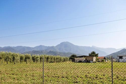 a fence in a field with mountains in the background at Casa Mary Vicino a Camaiore in Camaiore