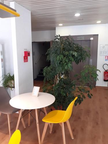 a table and chairs in an office with plants at EGG HOTEL - HOTEL LES GENS DE MER Dieppe in Dieppe