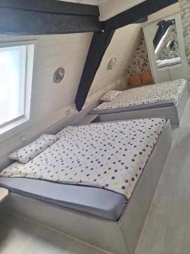 a bedroom with two bunk beds in a attic at Pension "Brückenschänke" in Nassau