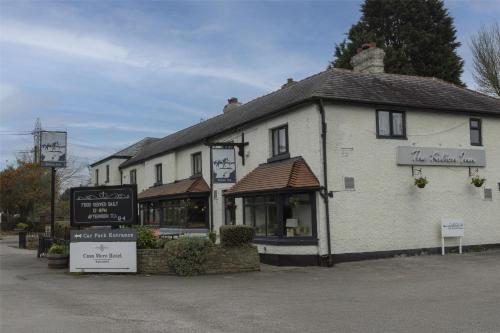 a white building with a sign in front of it at Casa Mere Manchester Airport, Knutsford, Sure Collection by Best Western in Knutsford