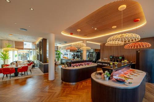 a restaurant with tables and chairs and a buffet at Hotel Verviers Van der Valk in Verviers