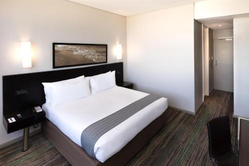 a bedroom with a large bed in a hotel room at Garden Court Kings Beach in Port Elizabeth