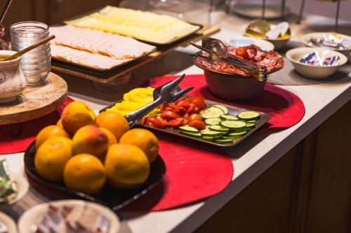 a buffet with fruits and vegetables on a table at Maksimilian Osijek in Osijek