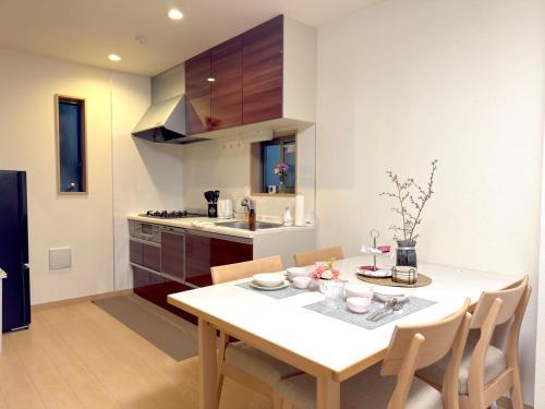 a kitchen and dining room with a table and chairs at 池袋銀婚屋 GINKOU's HOUSE -- 2 min train to Ikebukuro Sunshine City in Tokyo