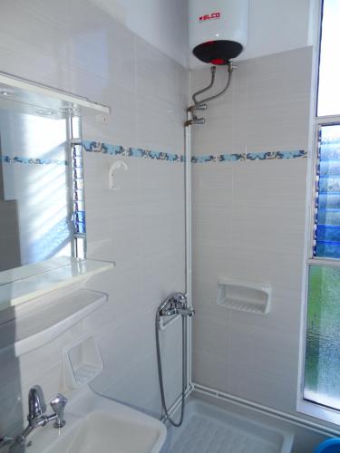 a bathroom with a shower and a sink at Nikos Apartments in Pefki