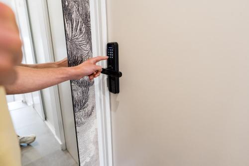 a person unlocking a door with a remote control at Ted Surf House in Capbreton