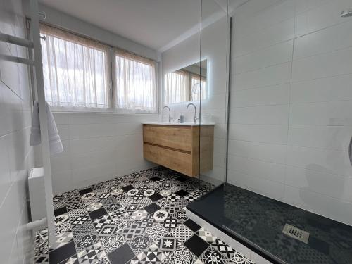 a bathroom with a sink and a mirror at La Cour de Mamama Appartement 4 in Ohnenheim