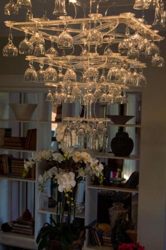 a chandelier with glasses and flowers in a room at Vineyard Views Country House in Riebeek-Kasteel