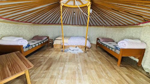 a room with two beds in a tent at Gaya's Guest House in Harhorin