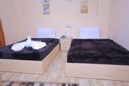 a bedroom with two beds withskirts at City Stars Hotel in Cairo