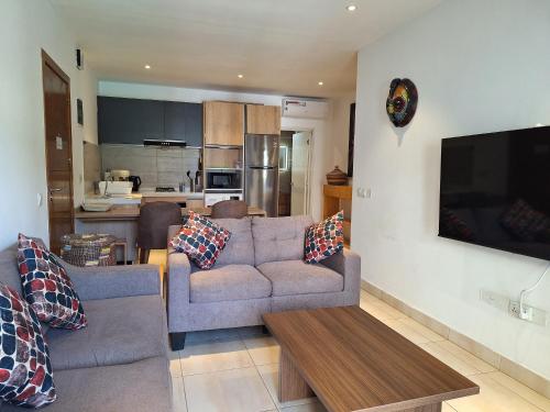 a living room with a couch and a table at Forest View Apartments in Kololi
