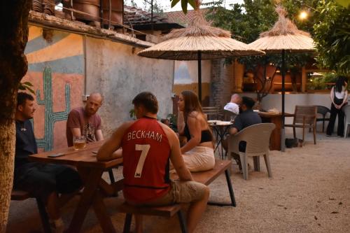 a group of people sitting at a table at Trip'n'Hostel Pink Bubble in Tirana