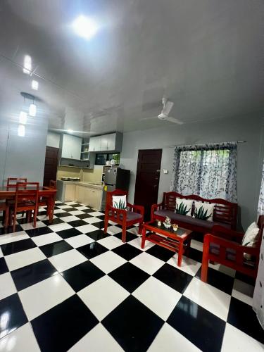 a living room with a black and white checkered floor at Publikhaus in Caliclic