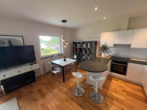 a kitchen with a table and a counter top at Caragh Lake House - Lakefront Escape and Sauna in Killorglin