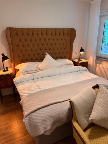 a large bed with a large headboard in a bedroom at Caragh Lake House - Lakefront Escape and Sauna in Killorglin