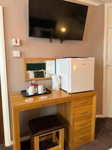 a kitchen counter with a microwave and a refrigerator at The Scala Hotel in Blackpool