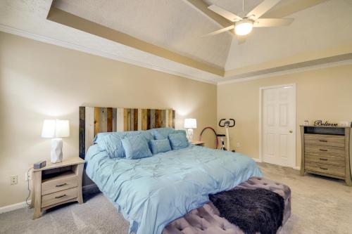 una camera da letto con un letto grande con un piumone blu di Shop, Fish and Explore Suburban Home in Loganville! a Loganville
