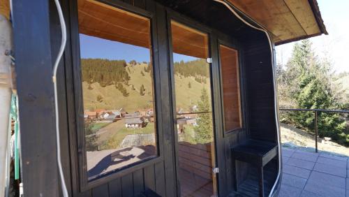 a room with a window with a view of a mountain at Gyimesi Skanzen in Valea Boroş