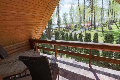 a screened in porch with a bench and trees at Atpūtas komplekss Lilaste in Lilaste