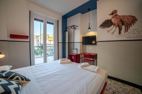 a bedroom with a bed with a bird on the wall at YellowSquare Milan in Milan