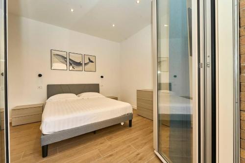 a bedroom with a bed and a mirror at Allegra elegance homes in Nettuno