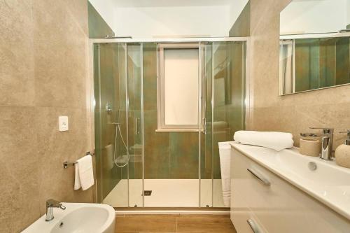 a bathroom with a shower and a sink at Allegra elegance homes in Nettuno