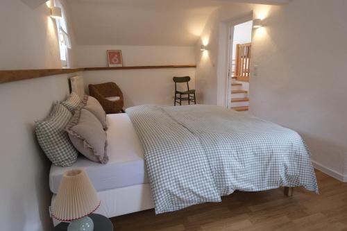 a bedroom with a bed and a staircase in the background at Das Eifel Türmchen in Bad Münstereifel