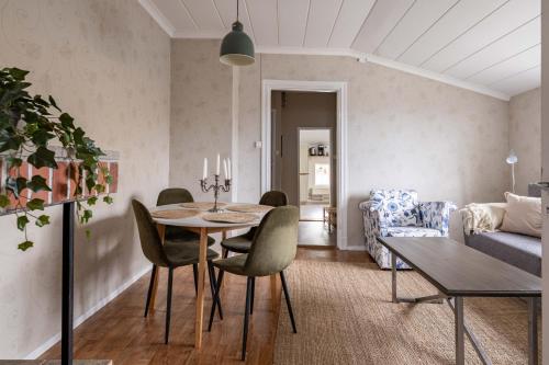 a living room with a table and a couch at Cozy apartment in the middle of Visby town in Visby