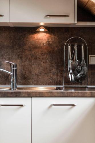 a kitchen counter with a sink and utensils at Moarhof Albeins in Albes