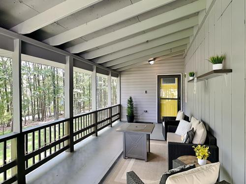 a screened in porch with couches and a table at In The Middle in Oakland