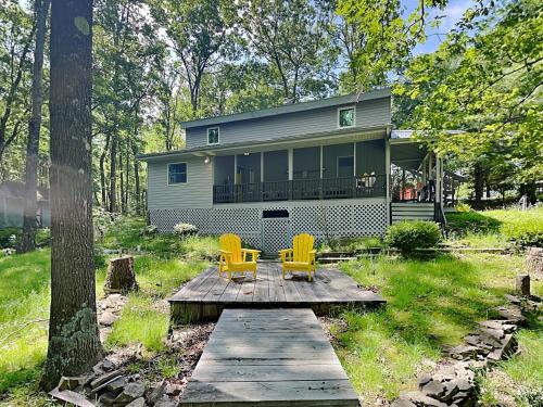 a house with two yellow chairs on a wooden deck at In The Middle in Oakland