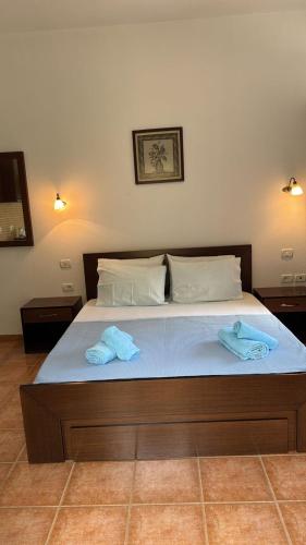 a bedroom with a bed with two towels on it at Filoxenia Residence in Palasë
