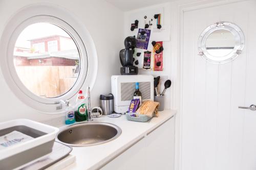 a kitchen counter with a sink and a window at 2 Bedroom Chalet With Sea Views in Plymouth