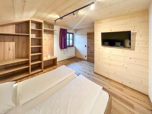 a living room with a couch and a tv at Madlhof in Himmelreich