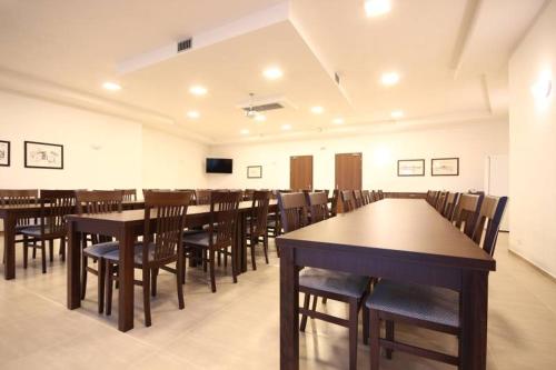 a conference room with tables and chairs and a television at Penzion Vlaštovka in Dolní Dunajovice