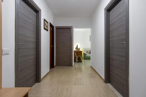 a hallway with wooden doors in a house at Dolomiapartments - Appartamento CENTRALE in Predazzo