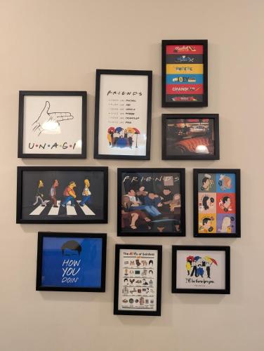 a wall with framed pictures on a wall at Tribe - Bespoke Hotel by FlxHo Arjun Marg DLF Phase 1 Golf Course Road in Gurgaon