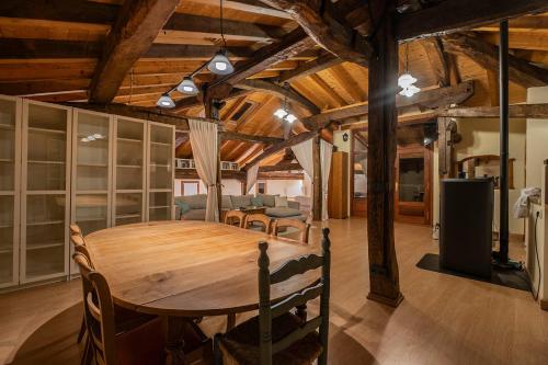 a dining room with a wooden table and chairs at Biendella El Desván 
