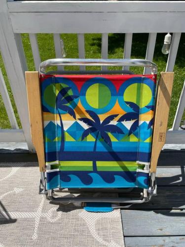 a colorful suitcase is sitting on a porch at Arlies Digs One Block To Willard Beach in South Portland