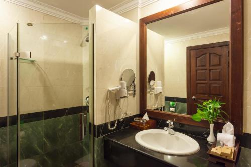 a bathroom with a sink and a shower at Prince Angkor Hotel & Spa in Siem Reap